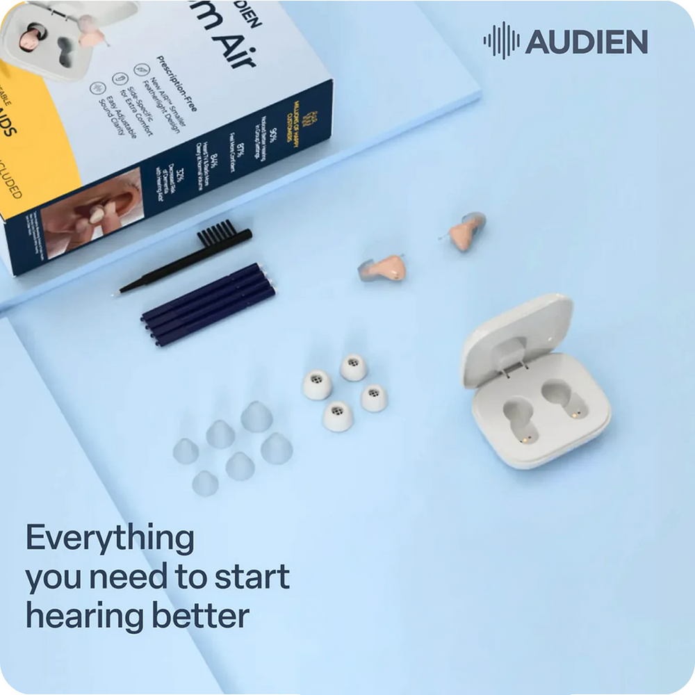 Audien earbuds and accessories arranged on a light blue background, including the open charging case, earbuds, multiple silicone ear tips, a cleaning brush, and the product box. The Audien brand name and logo appear in the top right, and text at the bottom reads 'Everything you need to start hearing better'.